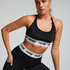 HKMX The Crop Logo Sports Bra Level 1, Black